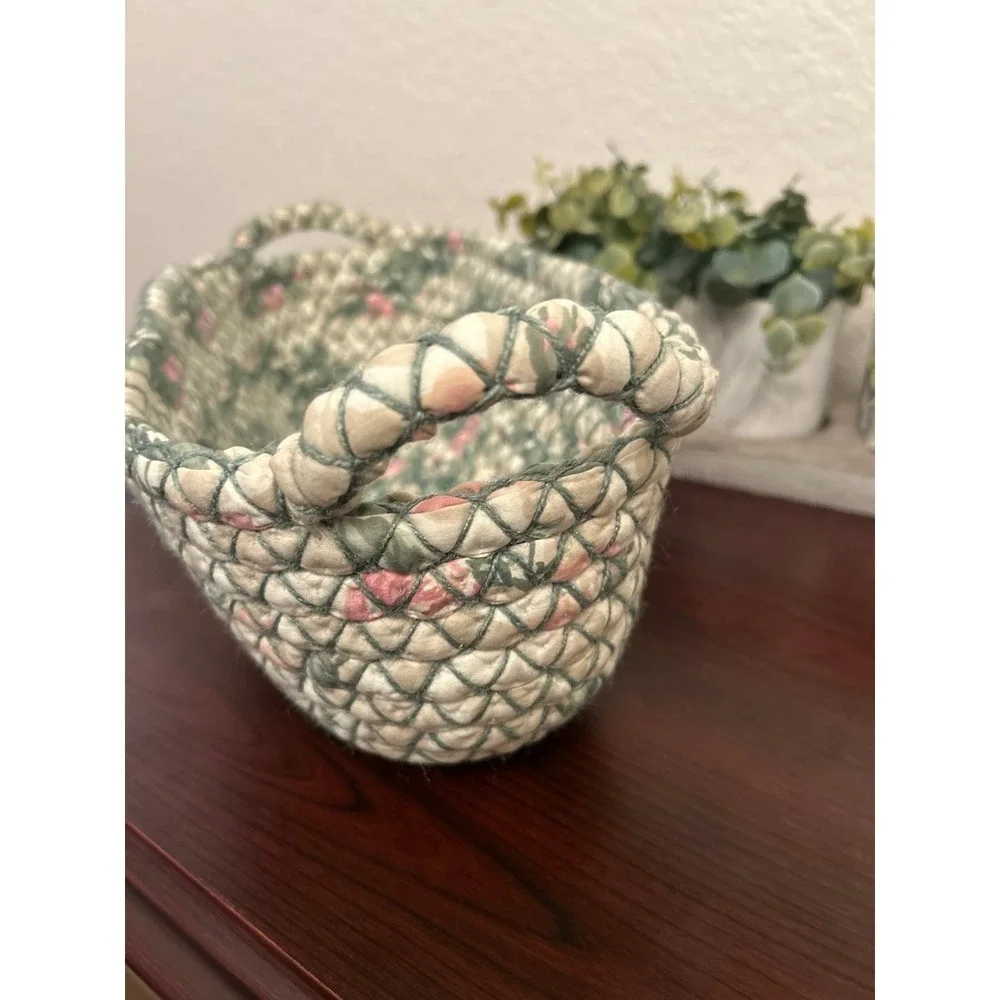vintage oval rag rug basket features a braided, quilted design in green and pink